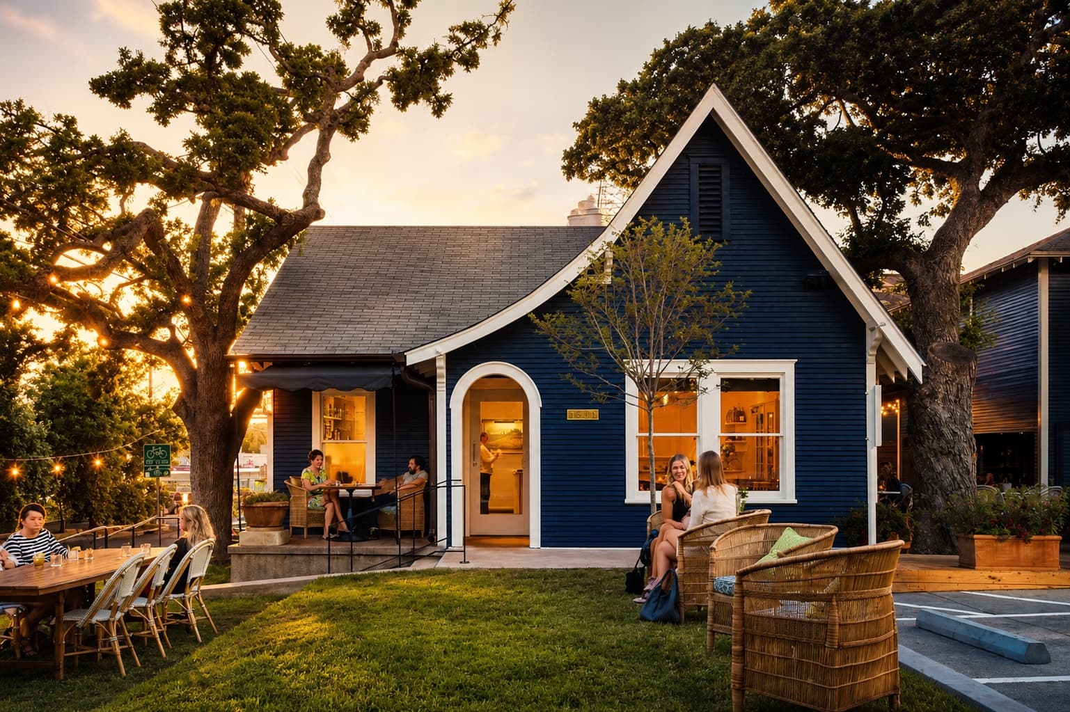 Josephine House, the historic blue cottage restaurant on Waterston Avenue, at golden hour in Clarksville, Austin
